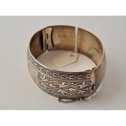 107 - A wide silver engraved hinged bangle   38 gms