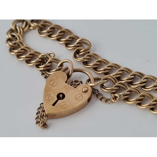 140 - A charm bracelet with heart padlock 9ct 7 inch   7.4 gms