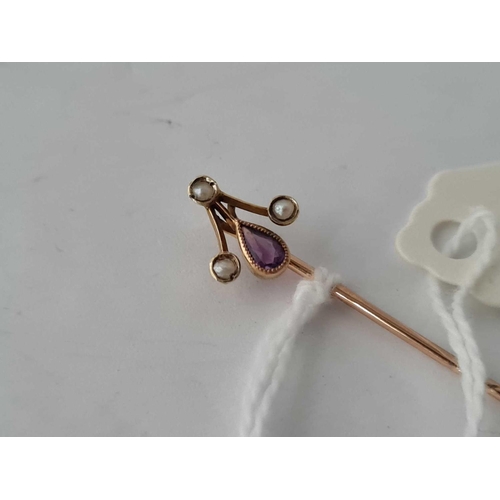 149 - A art nouveau amethyst and pearl gold set stick pin