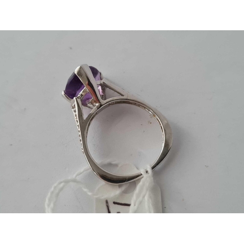 153 - A white gold triangular amethyst ring with diamond shoulder 9ct size O    4.3 gms