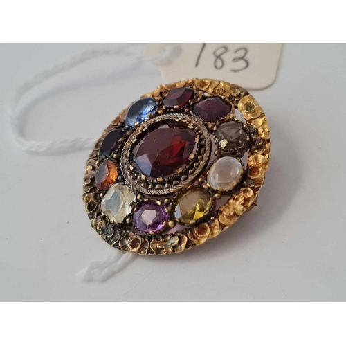 183 - A antique circular brooch set with semi precious stones    9.4 gms