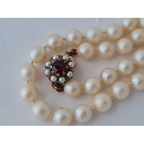 199 - A row of pearls with 9ct pearl and garnet clasp 17 inch