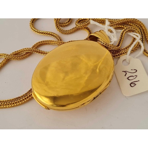 206 - A good gilt oval hinged locket set with three stones 2.5 inches on long gilt chain 32 inches