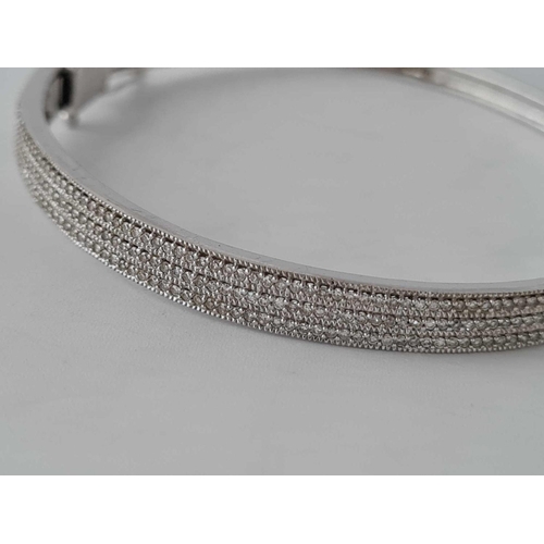 35 - A diamond multi stone set hinged bangle in 9ct white gold 13.5g inc