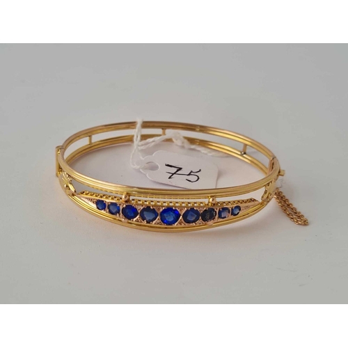 75 - Victorian detailed 9ct bangle set with blue stones possibly sapphires 7.8g inc