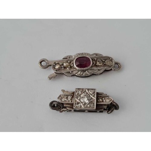 84 - Two platinum and white gold clasps with ruby and diamond