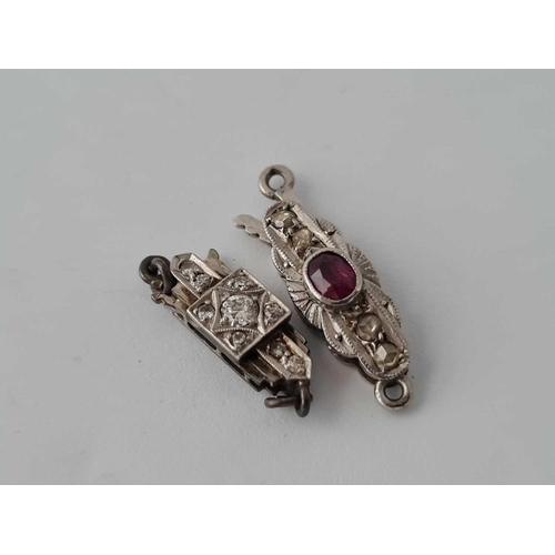 84 - Two platinum and white gold clasps with ruby and diamond