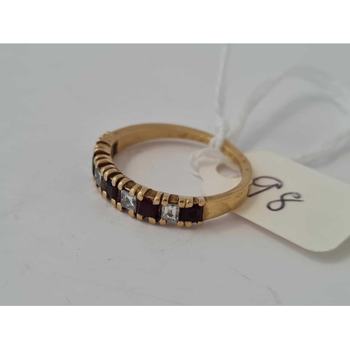 98 - A garnet half hoop ring 18ct gold size O    3 gms