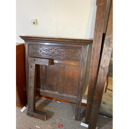 1717 - A Jacobean oak bedstead with carved panel end and wood supports