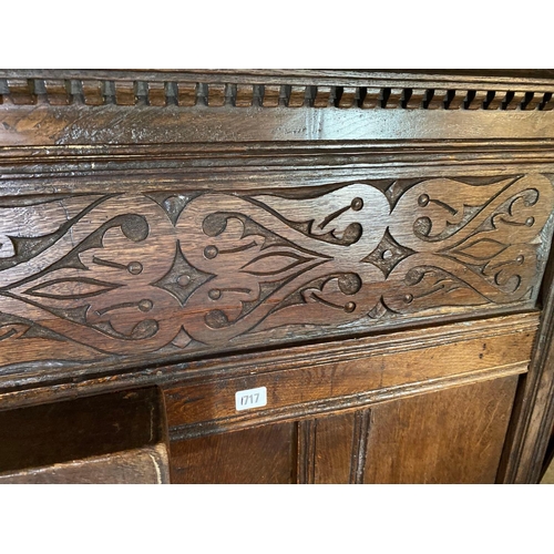 1717 - A Jacobean oak bedstead with carved panel end and wood supports