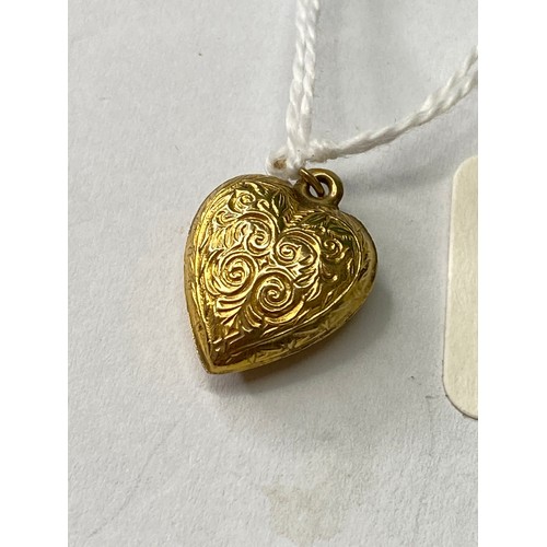 143 - A antique gold heart locket engraved with swirls 9ct