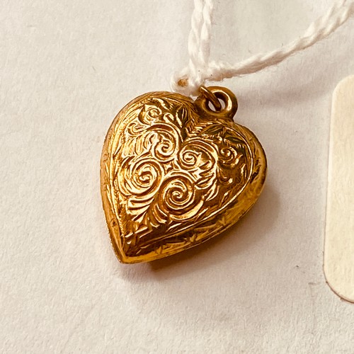 143 - A antique gold heart locket engraved with swirls 9ct