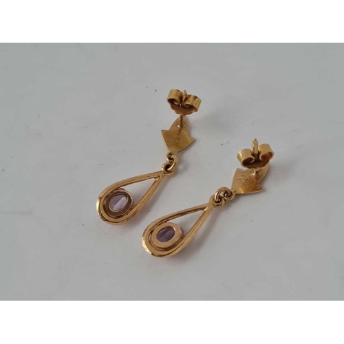 41 - A pair of amethyst set tear drop earrings 18ct gold 3.2g
