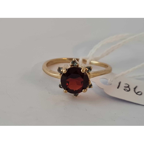 136 - A vintage garnet ring surrounded by green garnets size T 9ct       2.8 gms