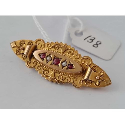 138 - A Victorian ruby and pearl brooch in relief and beaded gold workmanship 9ct      3 gms