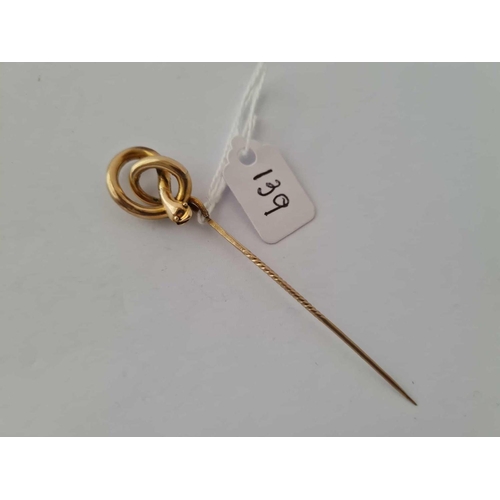 139 - A large swirled snake stock/stick pin in high carat gold