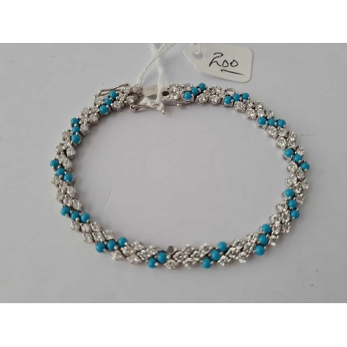 200 - A silver tennis bracelet set with white and turquoise atones