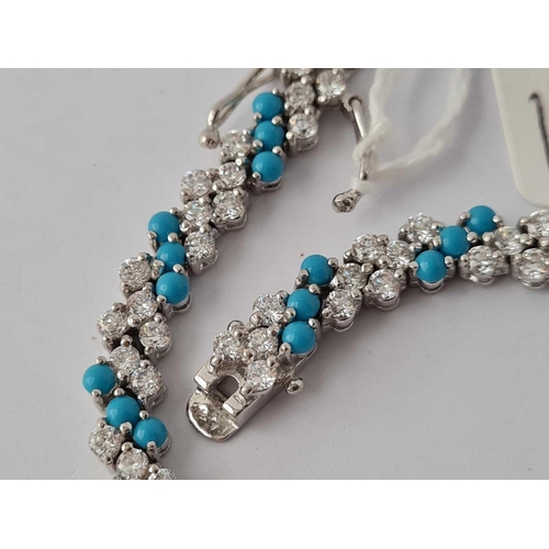 200 - A silver tennis bracelet set with white and turquoise atones