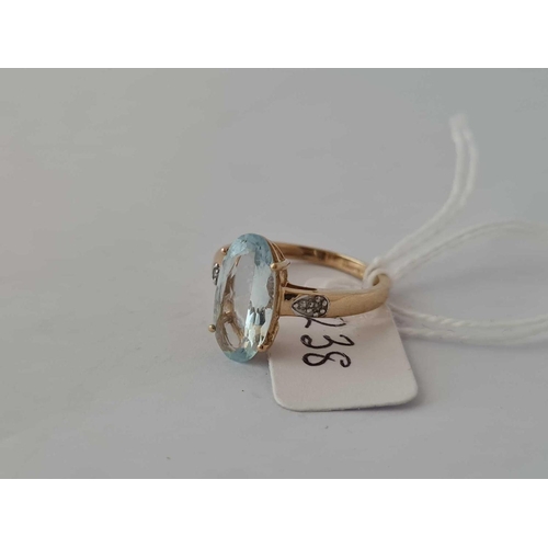 238 - A aquamarine oval centre stone ring with diamond shoulders 10ct gold  size O      2.2 gms