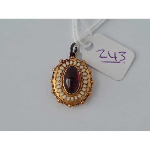 243 - A garnet and emerald locket pendant 15ct gold    4.3 gms