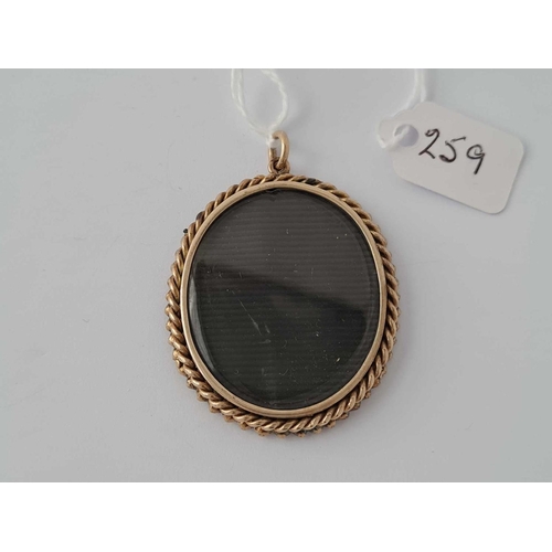 259 - A GEORGIAN GOLD AND FLAT CUT GARNET MEMORIAL LOCKET