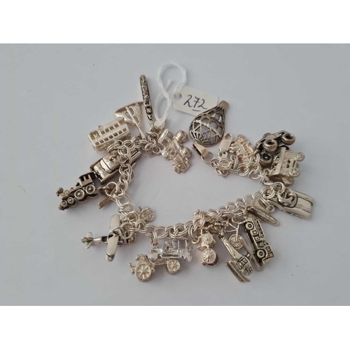 272 - Another silver charm bracelet with 21   �Age of travel� charms 65g