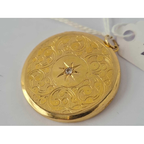 28 - 9ct circular locket with chased decoration and set with a centre diamond,
hallmarked Birmingham 1965... 