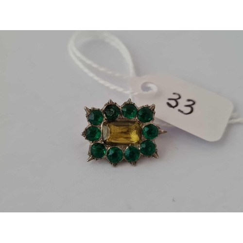 33 - A early Georgian green and yellow foil back memorial brooch in high carat gold in good condition