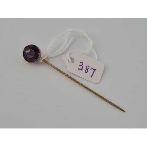 387 - A gold and amethyst stick pin    1.8 gms