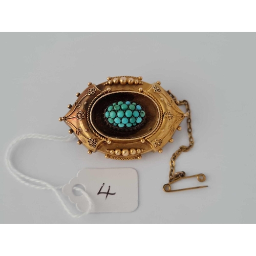 4 - A attractive gold oval fancy brooch with turquoise cluster to centre