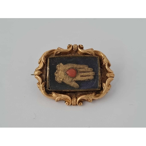 53 - A Georgian gold brooch with hand set coral stone