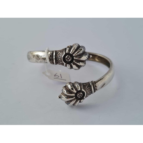 61 - An antique stylised torque silver bangle