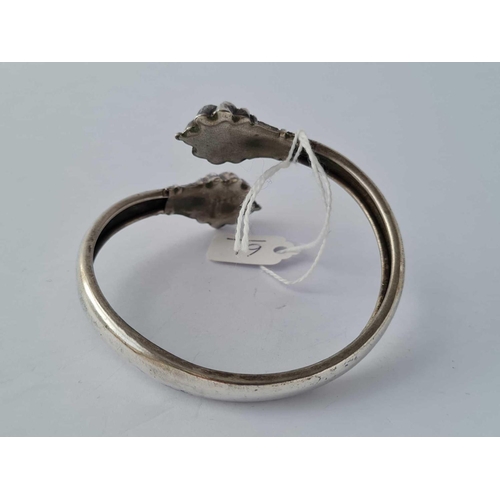 61 - An antique stylised torque silver bangle