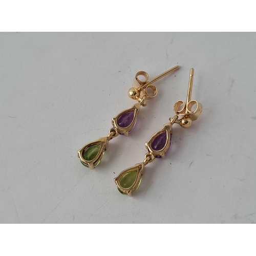 69 - A pair of peridot & amethyst gold drop earrings