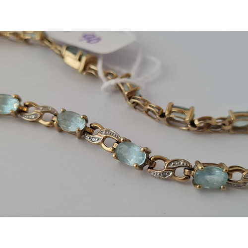 90 - A tennis bracelet set with topaz and diamonds 9ct 8 inch     8.2 gms (1 dia missing)