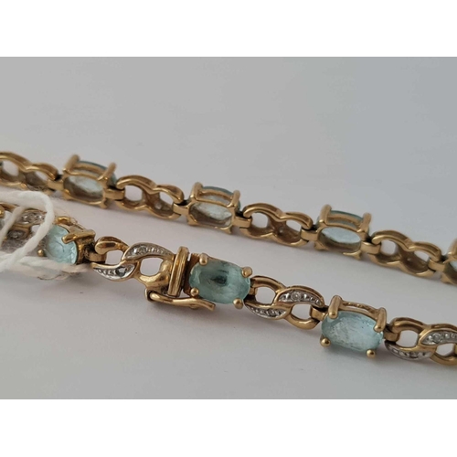 90 - A tennis bracelet set with topaz and diamonds 9ct 8 inch     8.2 gms (1 dia missing)