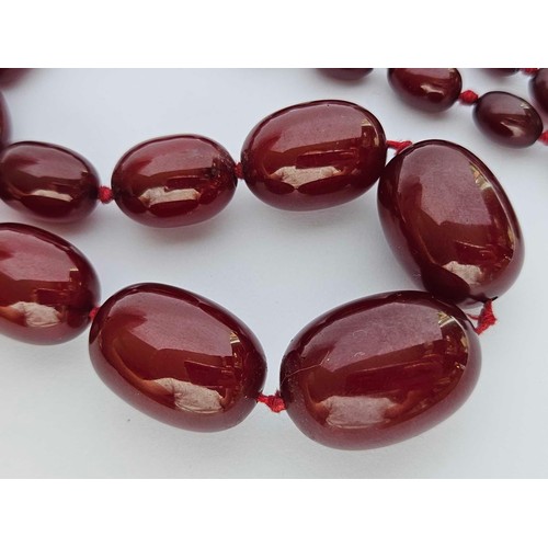 118 - A small string of cherry amber beads 26 inch 52 gms. Small bead approx 9mm wide, 8mm high. Large app... 