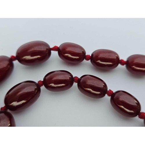 118 - A small string of cherry amber beads 26 inch 52 gms. Small bead approx 9mm wide, 8mm high. Large app... 