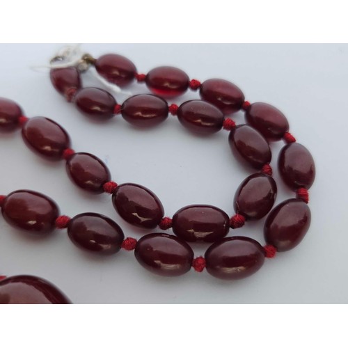 118 - A small string of cherry amber beads 26 inch 52 gms. Small bead approx 9mm wide, 8mm high. Large app... 