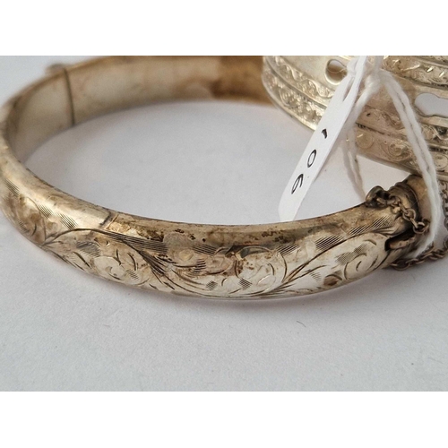 106 - A wide silver buckle bangle and one other