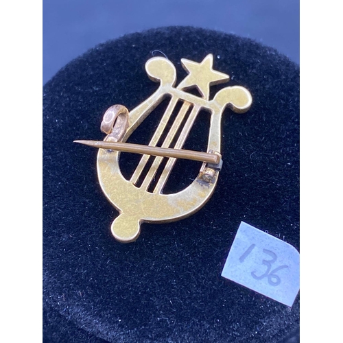 136 - A antique pearl lyre brooch in high carat gold tested