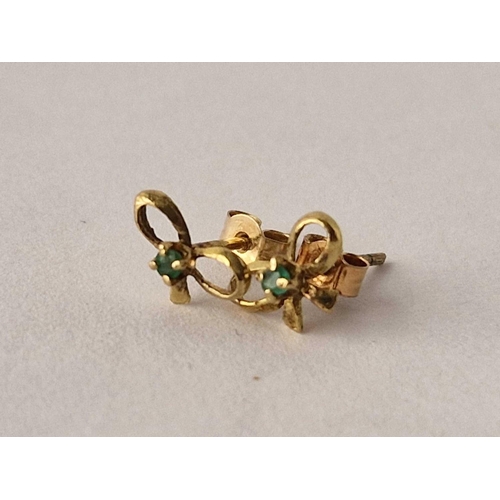 246 - A pair of emerald set bow shaped ear studs 9ct