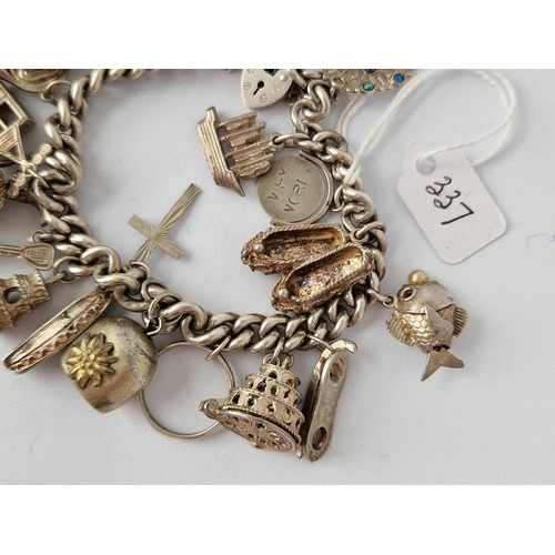 337 - A good silver charm bracelet 90 gms