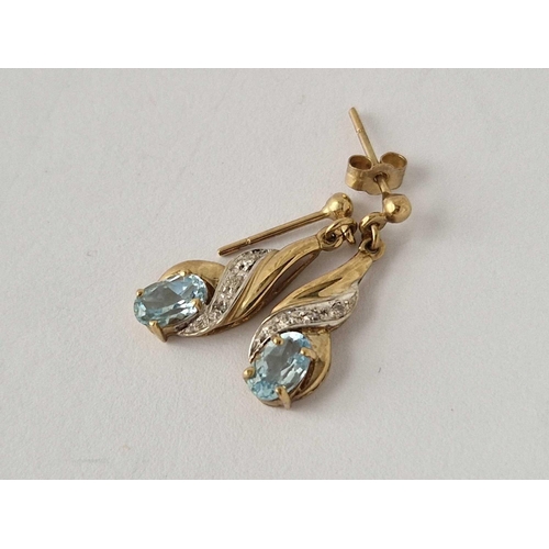 374 - A pair of diamond and topaz drop earrings