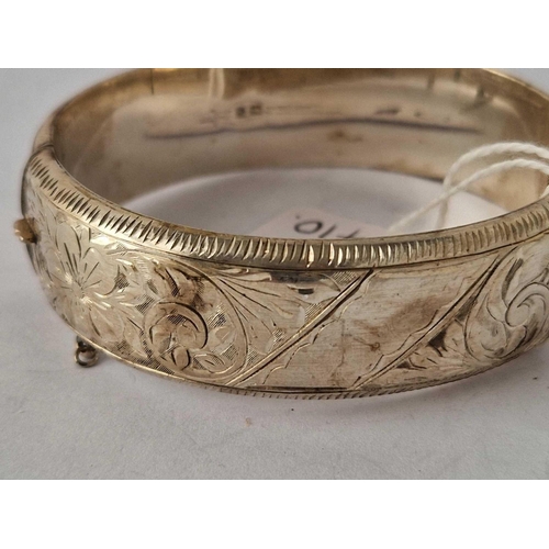 410 - A good wide engraved silver hinge bangle