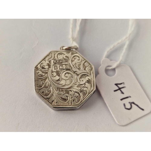 415 - Antique silver octagonal locket, hallmarked Birmingham 1913 with scroll decoration