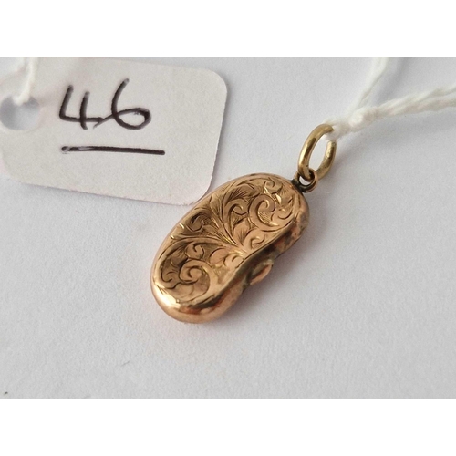 46 - A Victorian engraved kidney bean charm 9ct dented