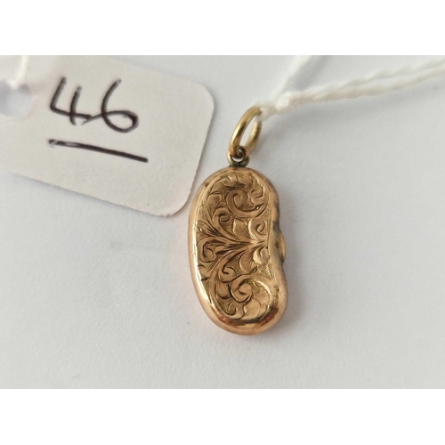 46 - A Victorian engraved kidney bean charm 9ct dented