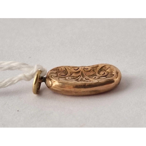 46 - A Victorian engraved kidney bean charm 9ct dented