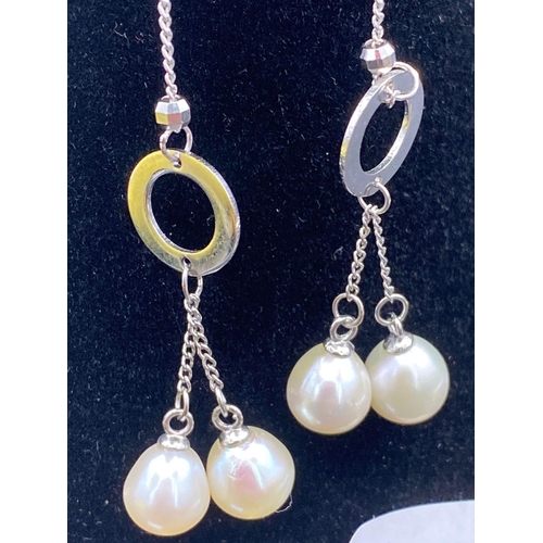 536 - A pair of silver double drop pearl ear pendants